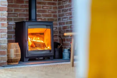 a brick fireplace with a fire in it at 4 Bed in Llanigon oc-t33091 in Llanigon