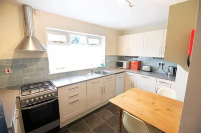 a kitchen with a sink and a stove top oven at Charming cottage in central Ludlow with parking in Ludlow