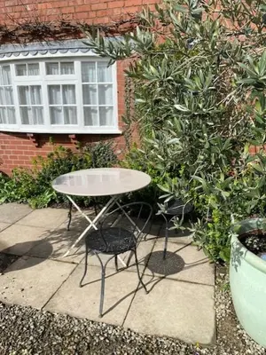 a table and chairs sitting in front of a window at Charming cottage in central Ludlow with parking in Ludlow