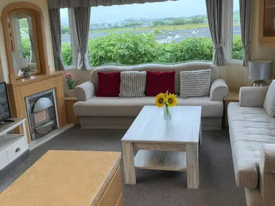 a living room with a couch and a table at Brynowen Holiday Park - Holiday Accommodation 19041 in Borth