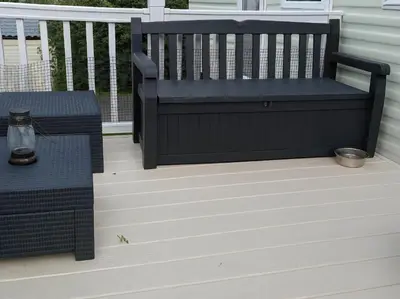 a bench on a deck with a table at Brynowen Holiday Park - Holiday Accommodation 19041 in Borth