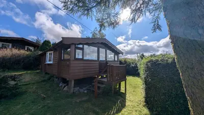 a small tree house in the grass in a yard at Eryri Retreat in Trawsfynydd