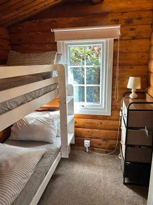 a bedroom with a bunk bed and a window at Eryri Retreat in Trawsfynydd