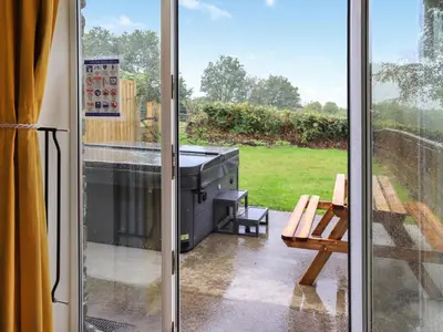 a screened in patio with a grill and a bench at Cothi Cottage - Uk49588 in Llansawel