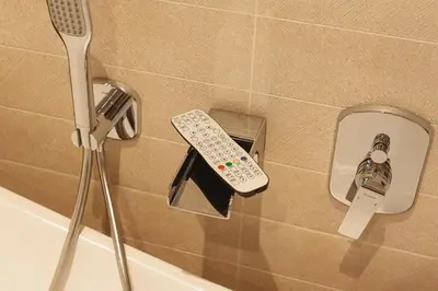 a remote control in the corner of a bath tub at 2 Bedroom Apartment - Parking - Walk to Town in Shrewsbury