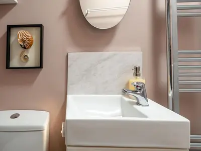 a bathroom with a sink and a mirror at Pass the Keys Charming 2 Bed Townhouse Short Walk To The River in Shrewsbury