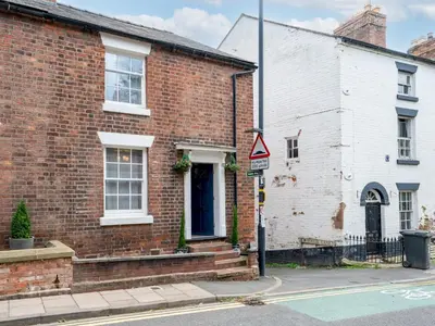 a brick house with a street sign in front of it at Pass the Keys Charming 2 Bed Townhouse Short Walk To The River in Shrewsbury