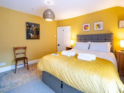 a bedroom with a large bed with two towels on it at Pass the Keys Charming 2 Bed Townhouse Short Walk To The River in Shrewsbury
