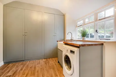 a laundry room with a washer and dryer at Luxury Cottage near Dolgellau in Llanfachreth