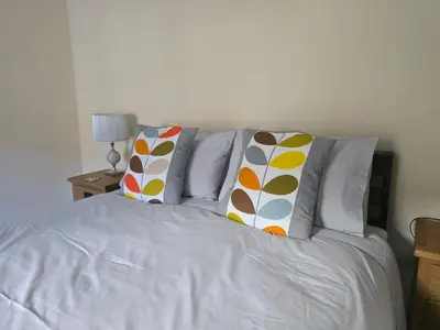 a white bed with pillows on top of it at Family room 2 - The Unicorn Hotel in Llanidloes