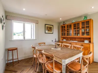 a kitchen and dining room with a table and chairs at Hoddell Pitch Cottage in Presteigne