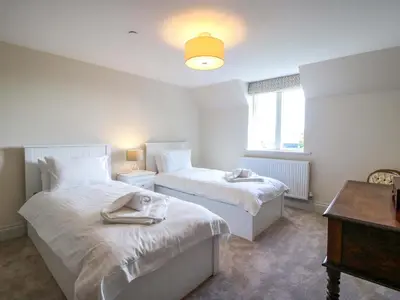 a bedroom with two beds with towels on them at Hoddell Pitch Cottage in Presteigne