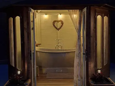 a bathroom with a tub with a heart on the wall at Y Cwlwm - The Celtic Knot in Lampeter
