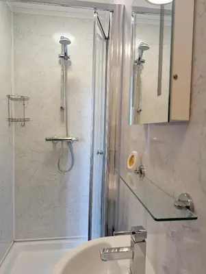 a bathroom with a shower and a sink at The Castle Inn in Wigmore