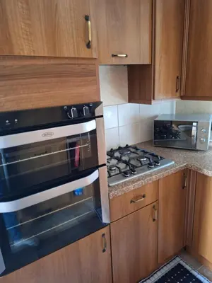 a kitchen with a stove and a microwave at TF1 Static in Aberystwyth