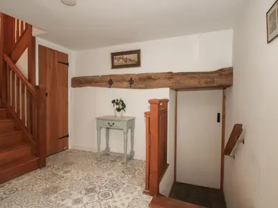 a hallway with a table and a stairway at Malt House in Bishops Castle