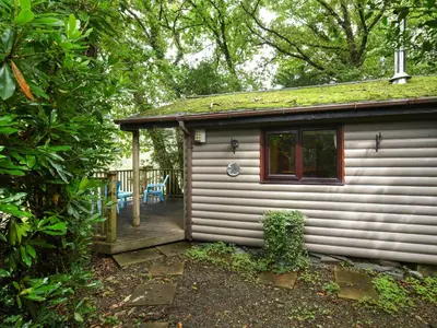a small house with a porch and a deck at The Owl's Nest - Uk50546 in Machynlleth