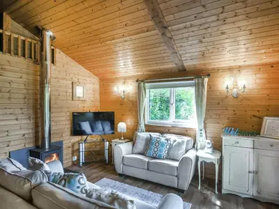 a living room with a couch and a tv at The Owl's Nest - Uk50546 in Machynlleth