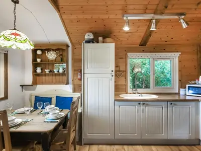 a kitchen and dining room with a table and a sink at The Owl's Nest - Uk50546 in Machynlleth