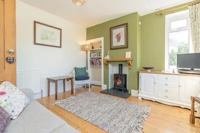a living room with a couch and a fireplace at Artro in Llanbedr