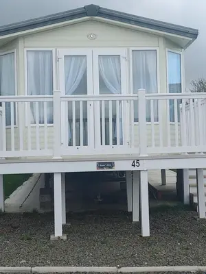 a large white house with a white railing at Rosie's Rest in Aberaeron