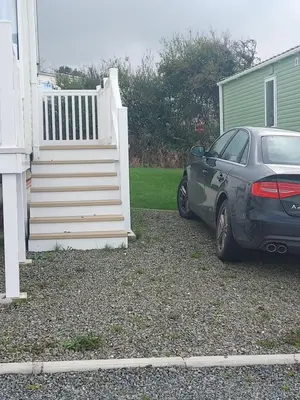 a car parked in front of a house with a staircase at Rosie's Rest in Aberaeron