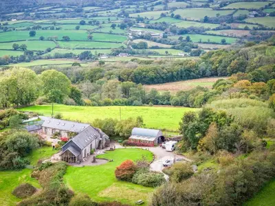 an aerial view of a farm house in a field at West Barn - 2 Bedroom Cottage - Llandeilo in Llandeilo