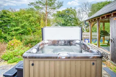 a jacuzzi tub sitting in a yard at West Barn - 2 Bedroom Cottage - Llandeilo in Llandeilo