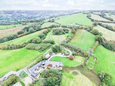 an aerial view of a house in a field at West Barn - 2 Bedroom Cottage - Llandeilo in Llandeilo