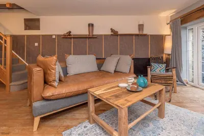a living room with a couch and a table at Cefn-Isaf in Llanbedr