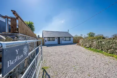 a house with a sign in front of it at Y-Berllan in Dyffryn