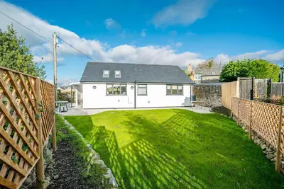 a white house with a yard in front of it at Y-Berllan in Dyffryn