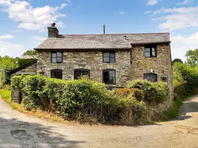 an old stone house on the side of a road at Lower Rheol in Erwood