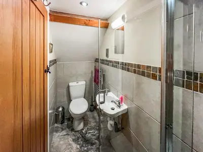 a bathroom with a toilet and a sink at The Dairy -Uk50616 in Corwen