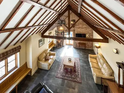 an overhead view of a living room with wooden ceilings at The Dairy -Uk50616 in Corwen