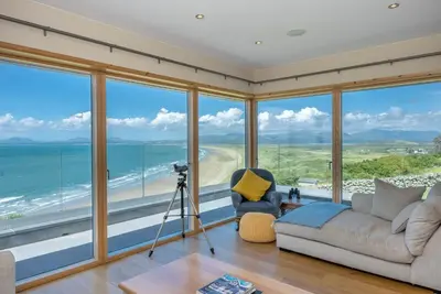 a living room with a view of the ocean at Sarn-Badrig in Harlech