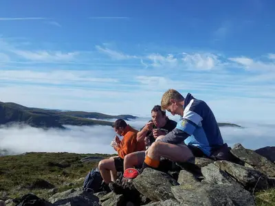 a group of men sitting on top of a mountain at Rheithordy in Blaenau-Ffestiniog