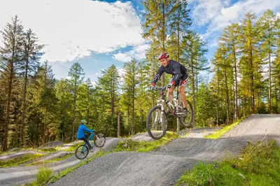 a man is doing a trick on a bike at Rheithordy in Blaenau-Ffestiniog