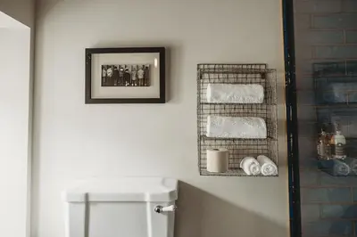 a bathroom with a towel rack above a toilet at Ty Mawr, The Old School Holiday Homes - Pet Friendly in Llanwrtyd Wells