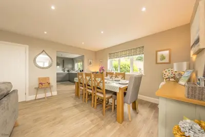 a kitchen and dining room with a table and chairs at Tan-Y-Foel in Dyffryn