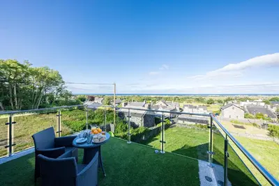 a view from the balcony of a house with a table and chairs at Tan-Y-Foel in Dyffryn