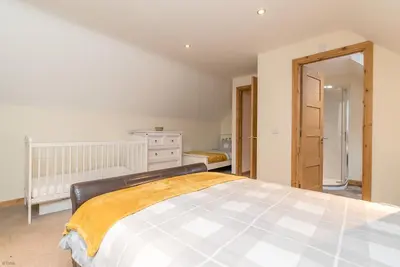 a bedroom with a large bed in a room at Maes-Artro-Lodge in Llanbedr
