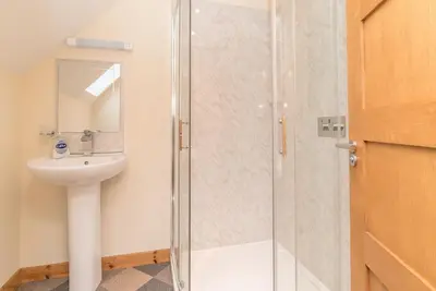a bathroom with a shower and a sink at Maes-Artro-Lodge in Llanbedr