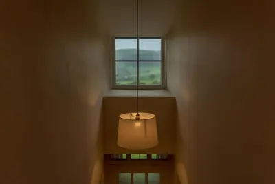 a light fixture in a room with a window at Ceseilgwm in Corwen