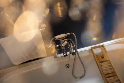 a kitchen sink with a faucet in a window at Isgoed in Talsarnau