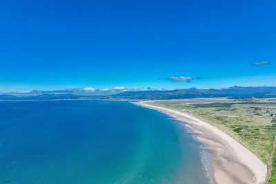 an aerial view of a beach and the ocean at Bwthyn-Bennar in Dyffryn