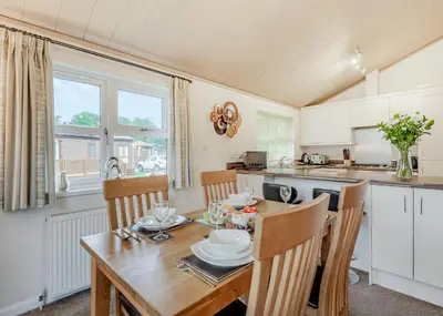 a kitchen and dining room with a wooden table and chairs at Beautiful Home In Bala, Gwynedd W in Llanfor