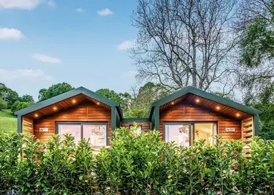 a log cabin in the woods with windows at Beautiful Home In Bala, Gwynedd W in Llanfor