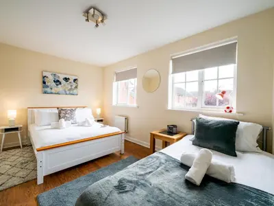 a bedroom with two beds and a window at Pass the Keys 3 Bedroom home local to Ludlow town centre in Ludlow