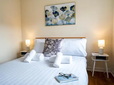a bed with a pair of glasses and a book on it at Pass the Keys 3 Bedroom home local to Ludlow town centre in Ludlow